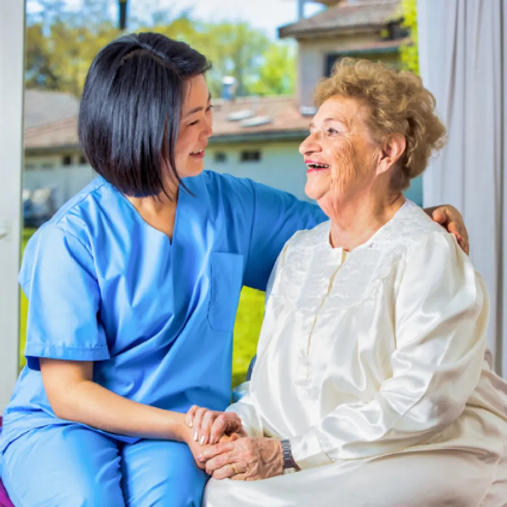 A NJ TLC caregiver sharing a warm moment with a client